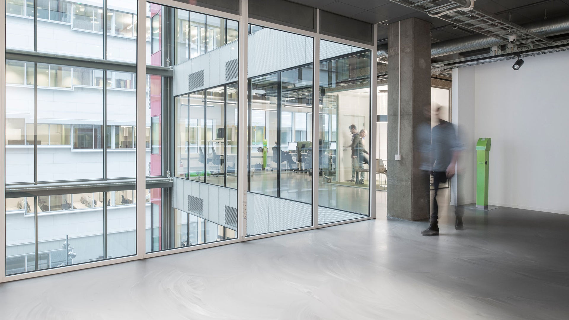 man walking on sika comfortfloor in office of fortum charge & drive arena city