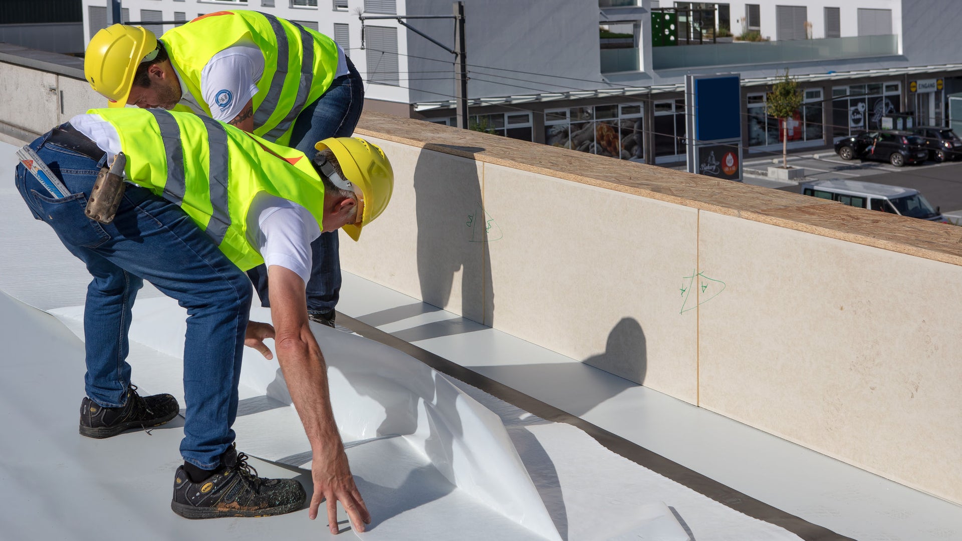 men applying roofing membrane