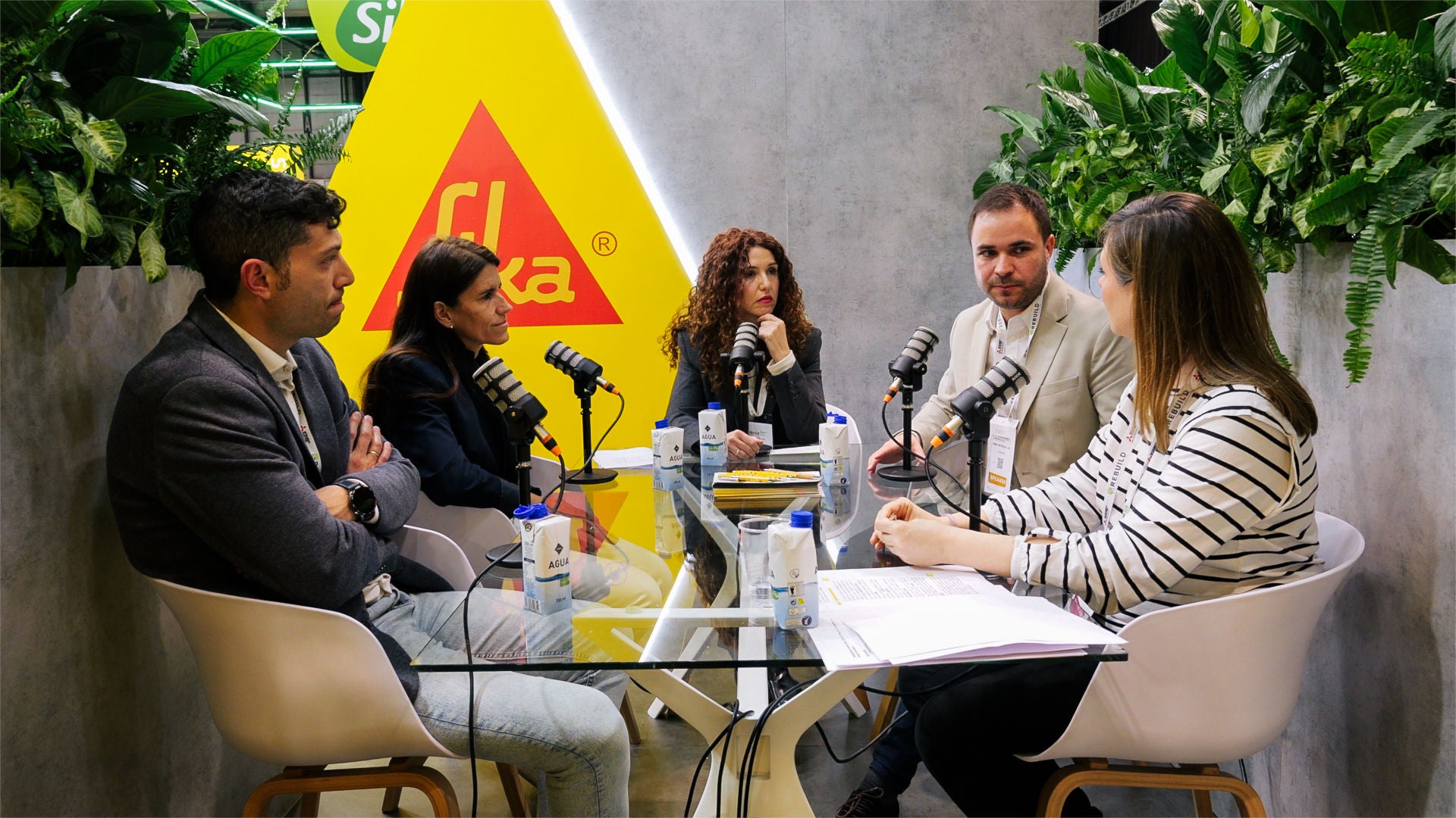 Group podcast recording at modern studio table