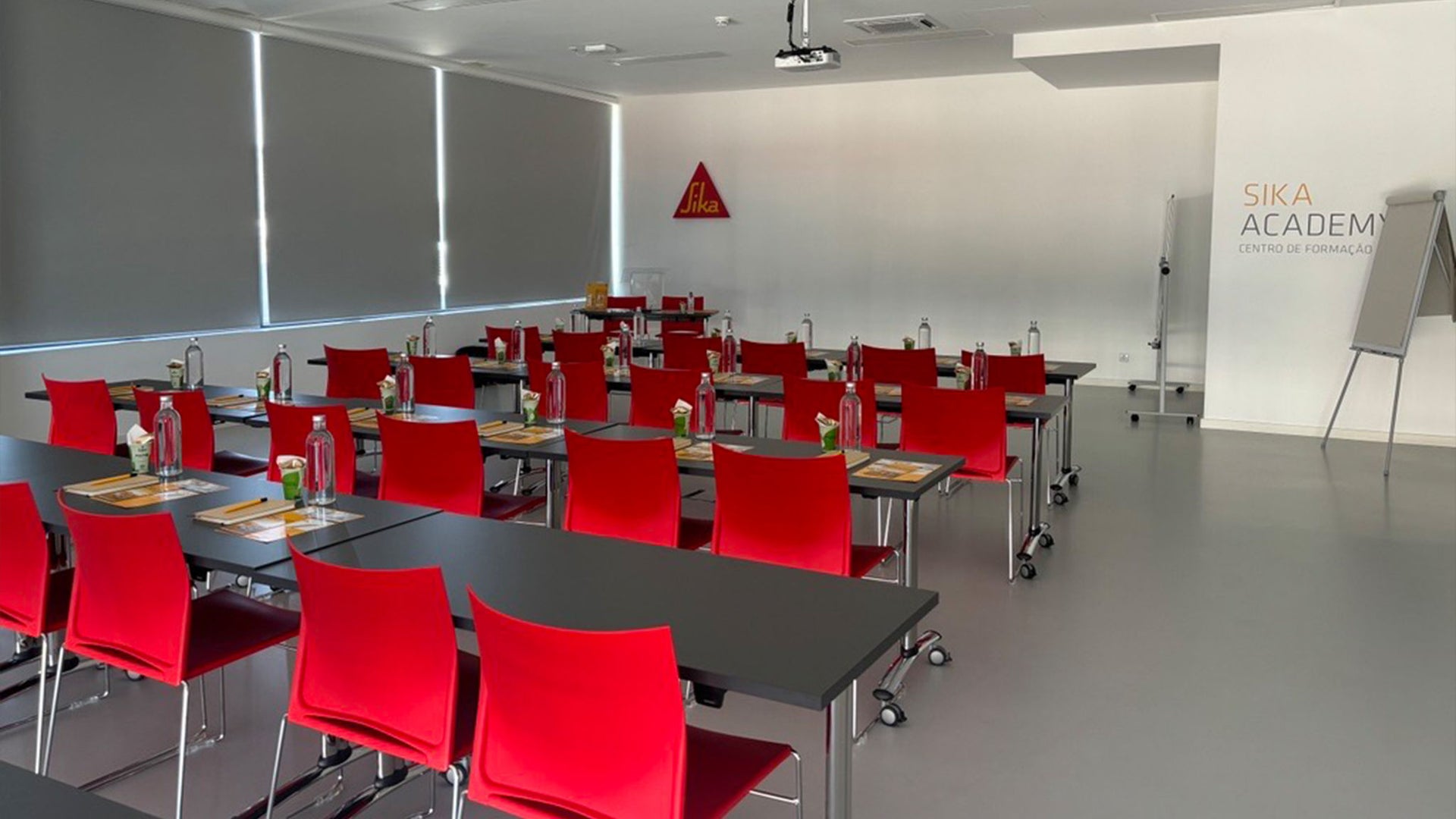 Modern training classroom with red chairs and supplies
