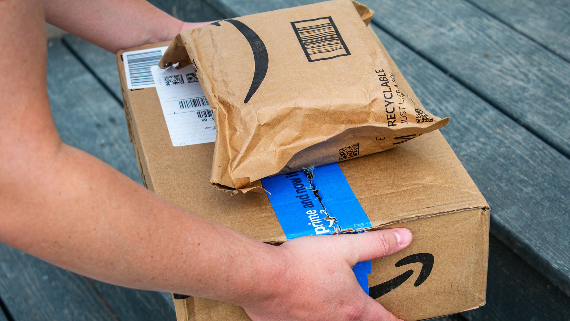 Person carrying cardboard delivery packages