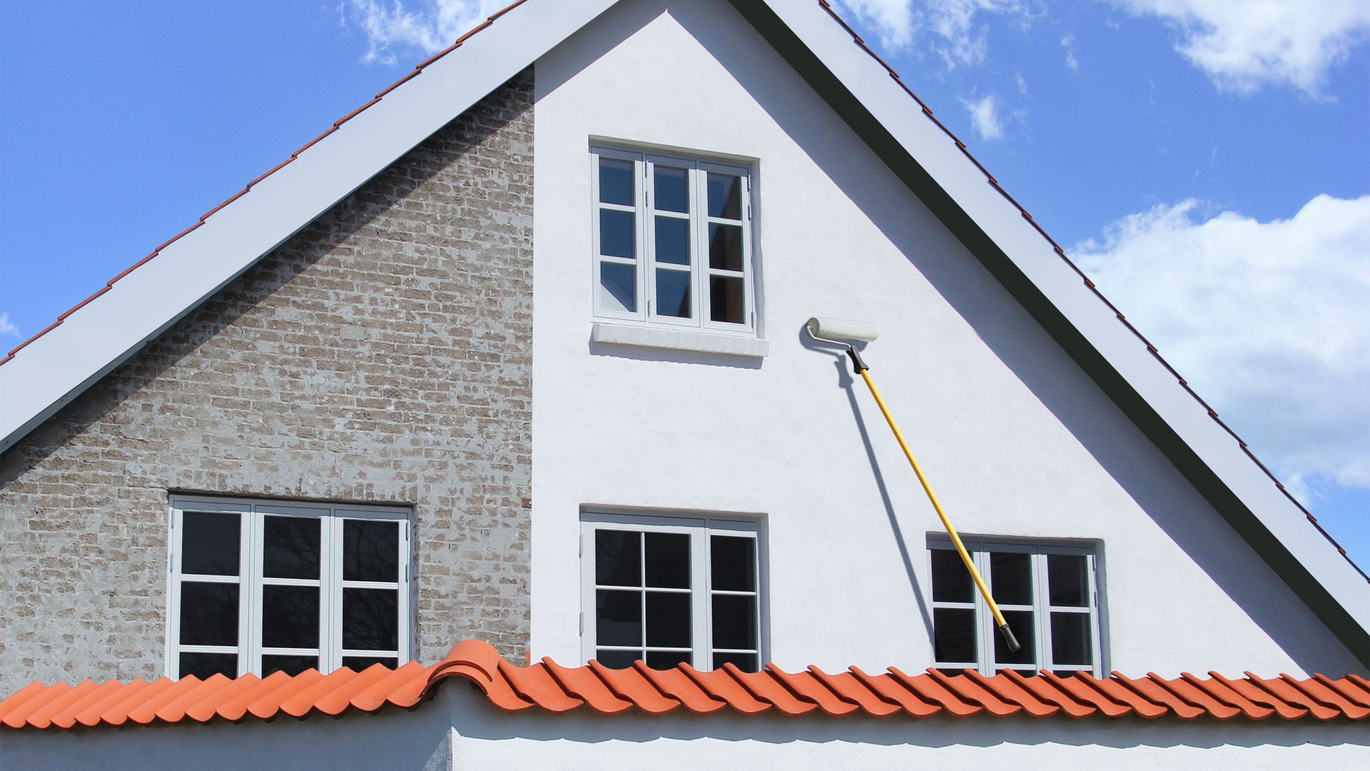 SikaWall white paint applied to house facade with roller and paintbrush