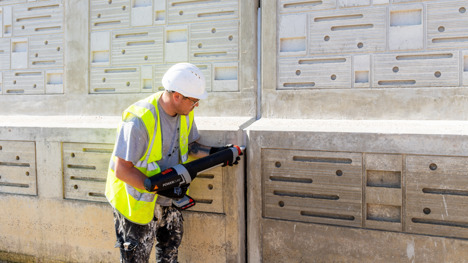 man applying sealant to wall joint