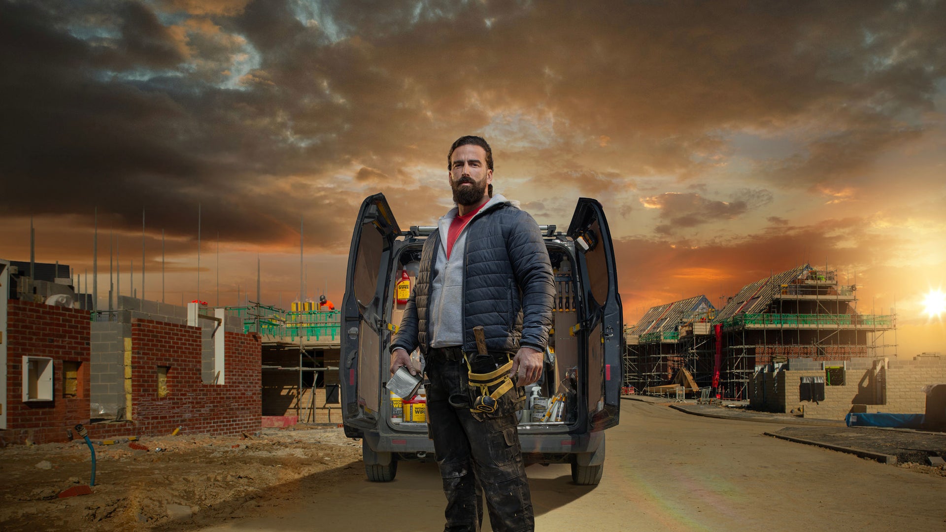 man stood in front of van on building site