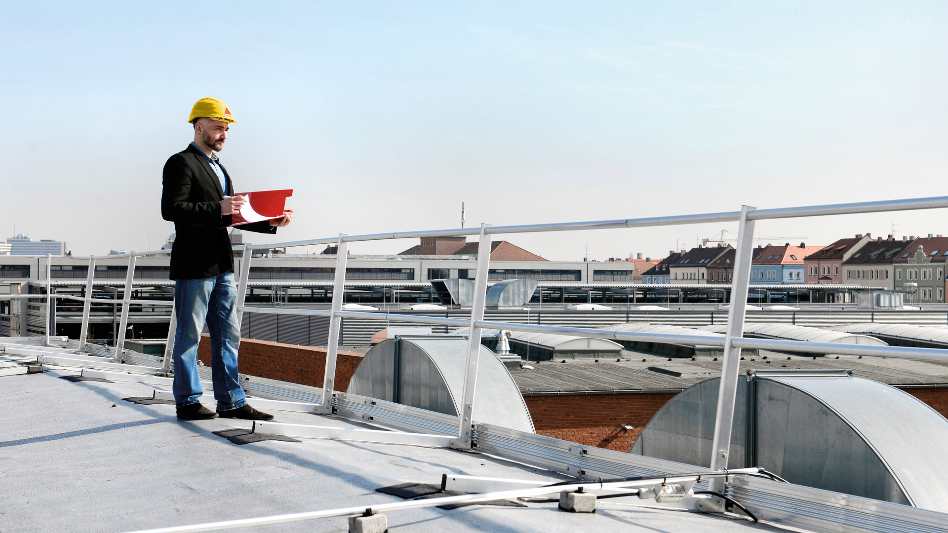 Engineer inspecting industrial rooftop construction site