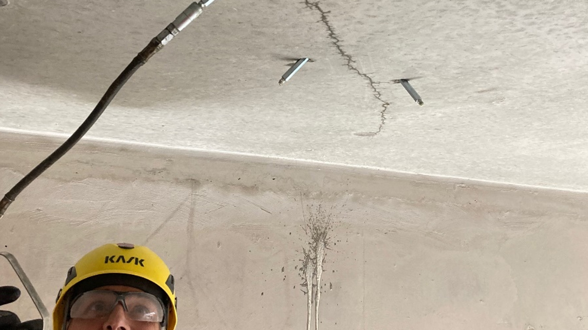 man applying waterproof injection to concrete