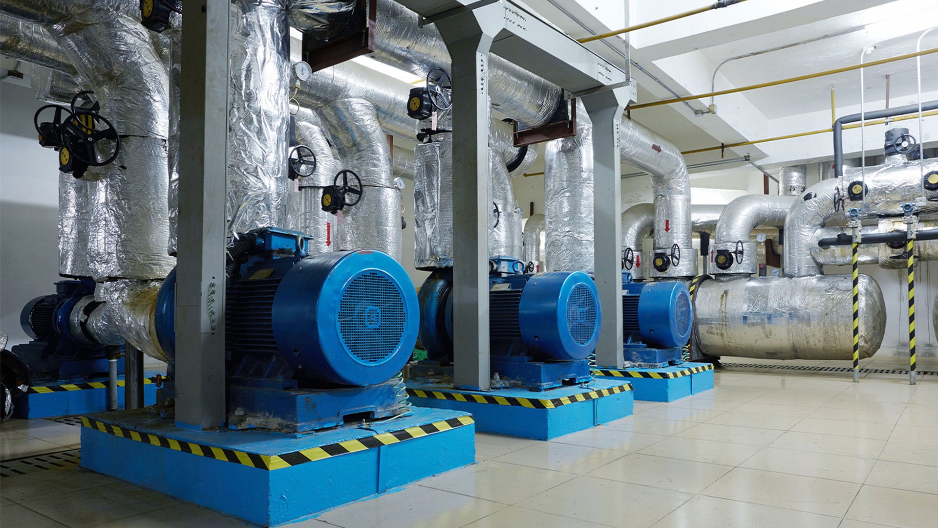 Industrial mechanical room with large blue motors