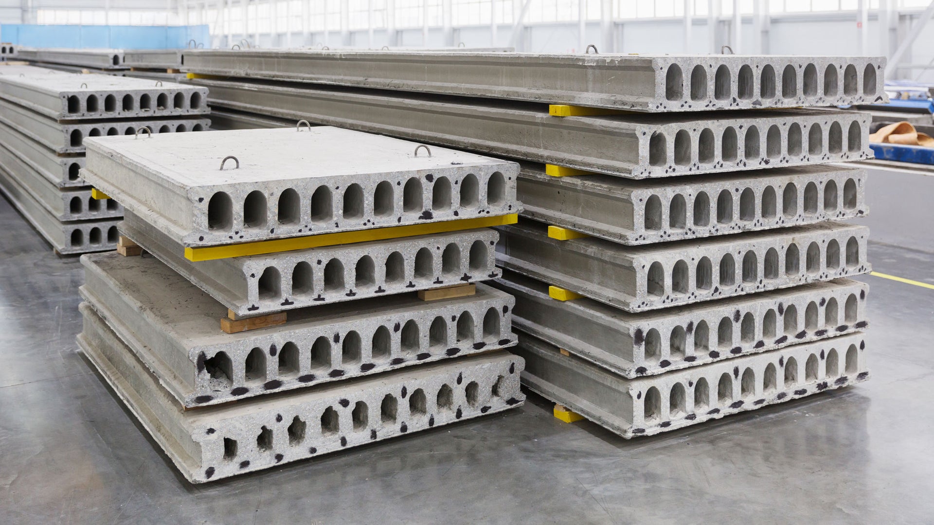 Stack of precast reinforced concrete slabs in factory workshop