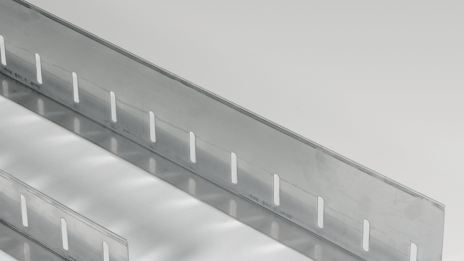 Slotted Metal Channel Sections on White Background