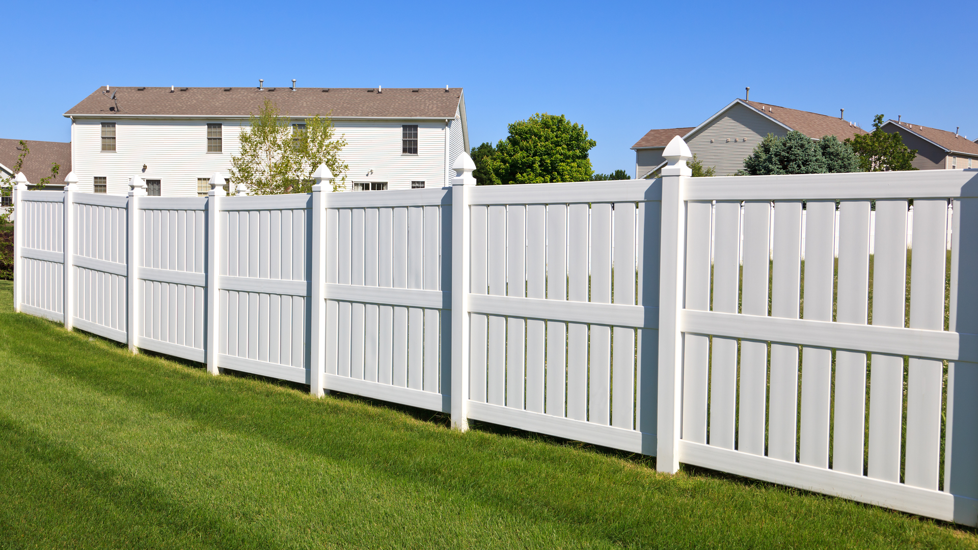 White vinyl fence in suburban neighborhood