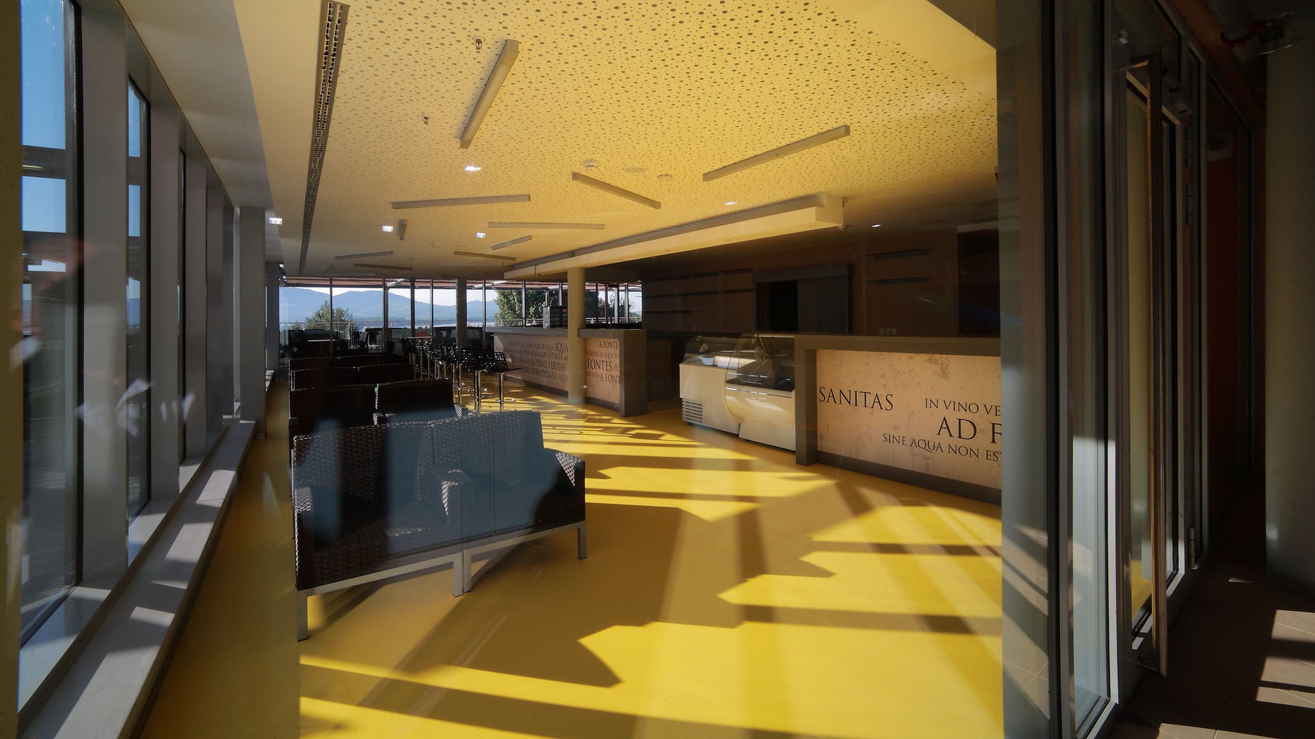 Modern sunlit waiting area with yellow floor