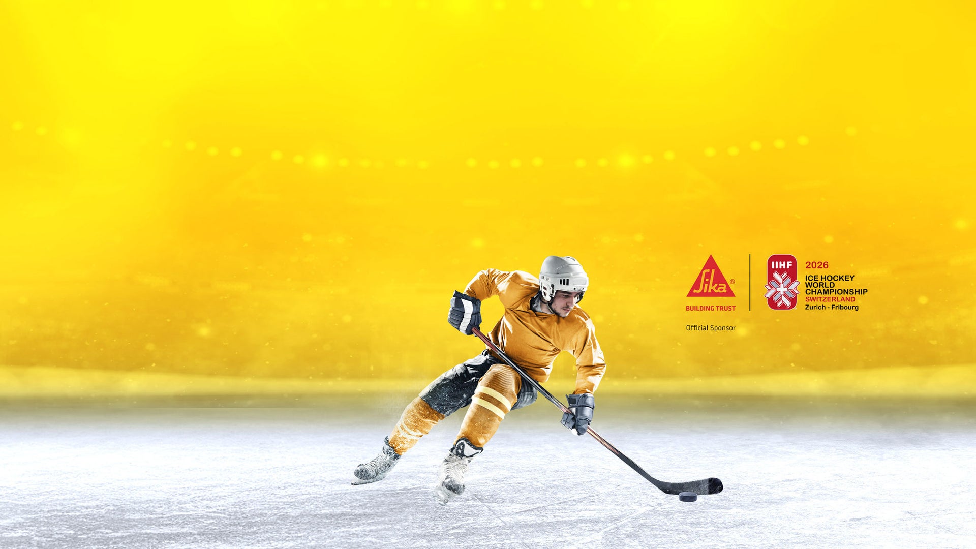 Ice hockey player in yellow uniform on rink