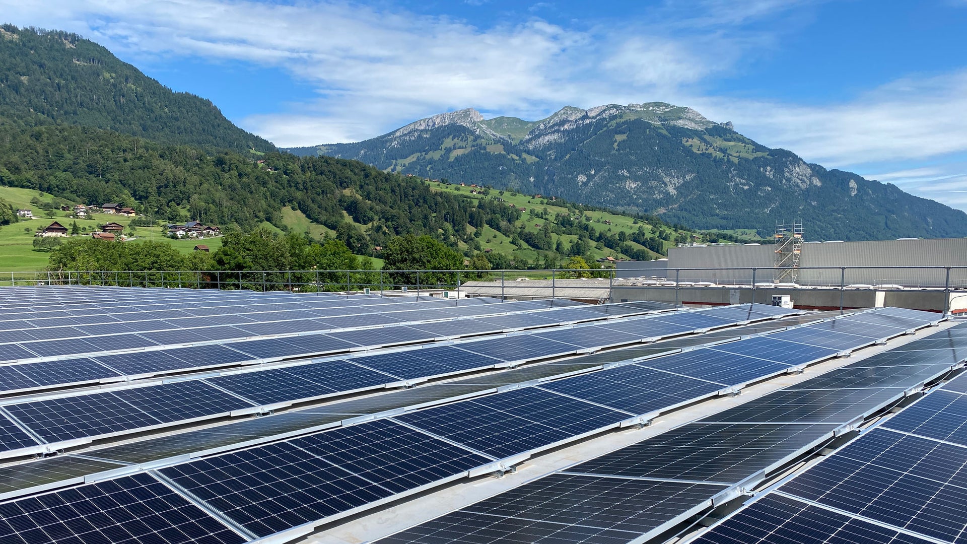 Sika solar mount system with PV panels on rooftop with mountains and blue sky