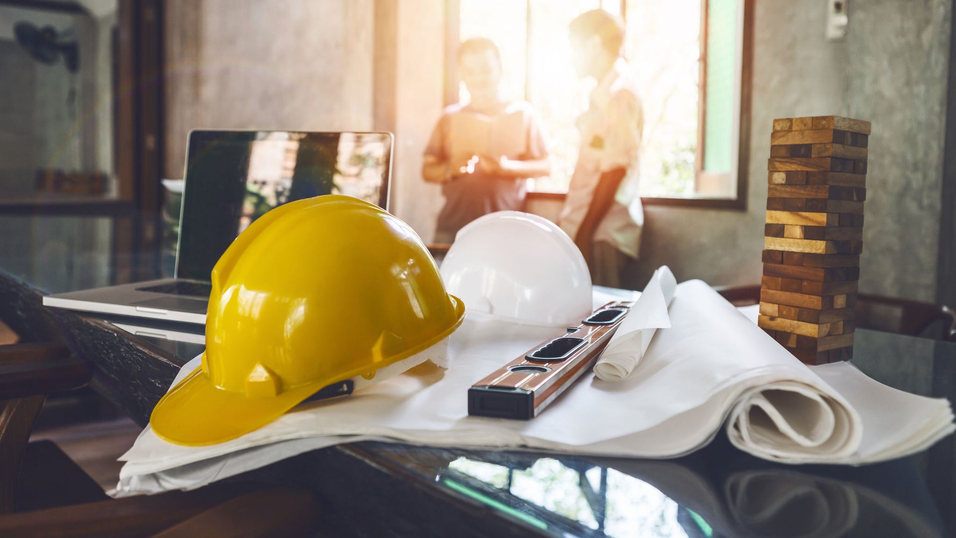 Construction planning meeting with safety helmets
