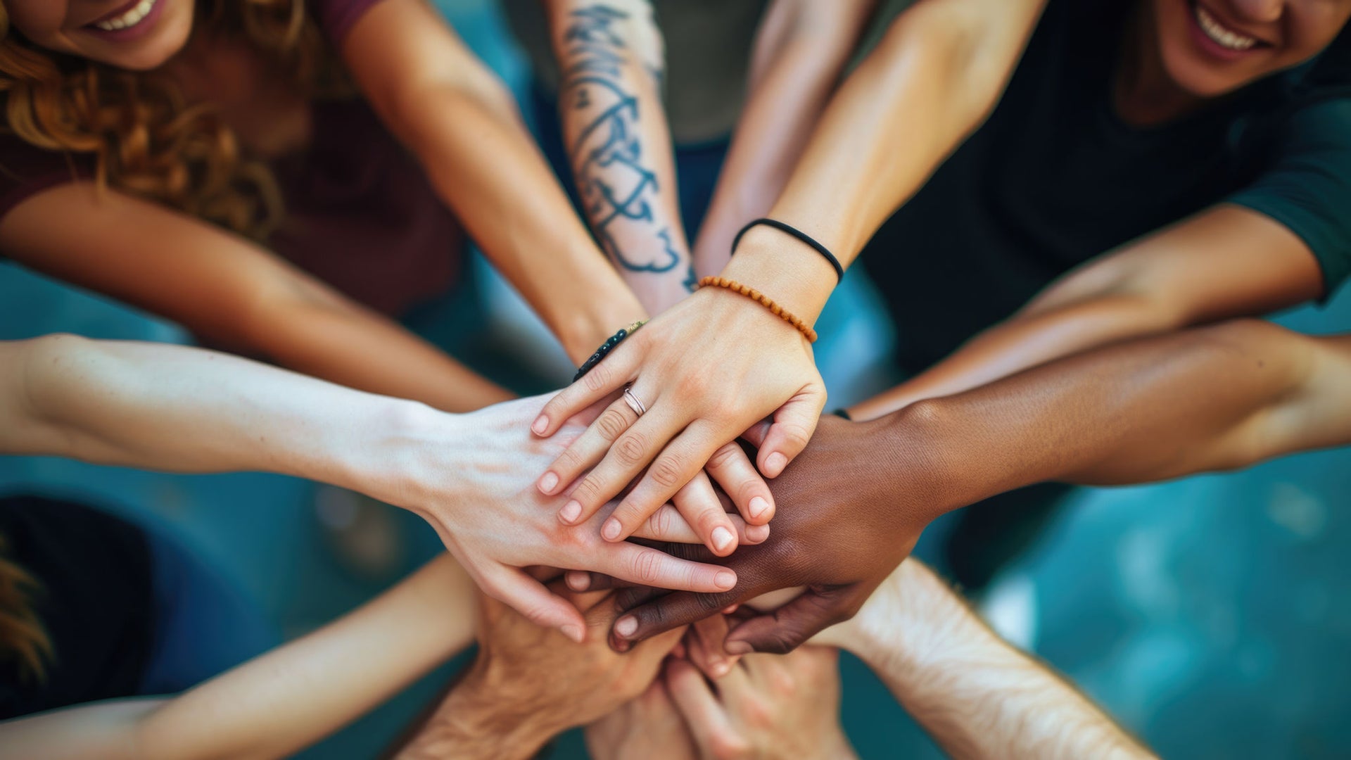 Diverse group joining hands in unity