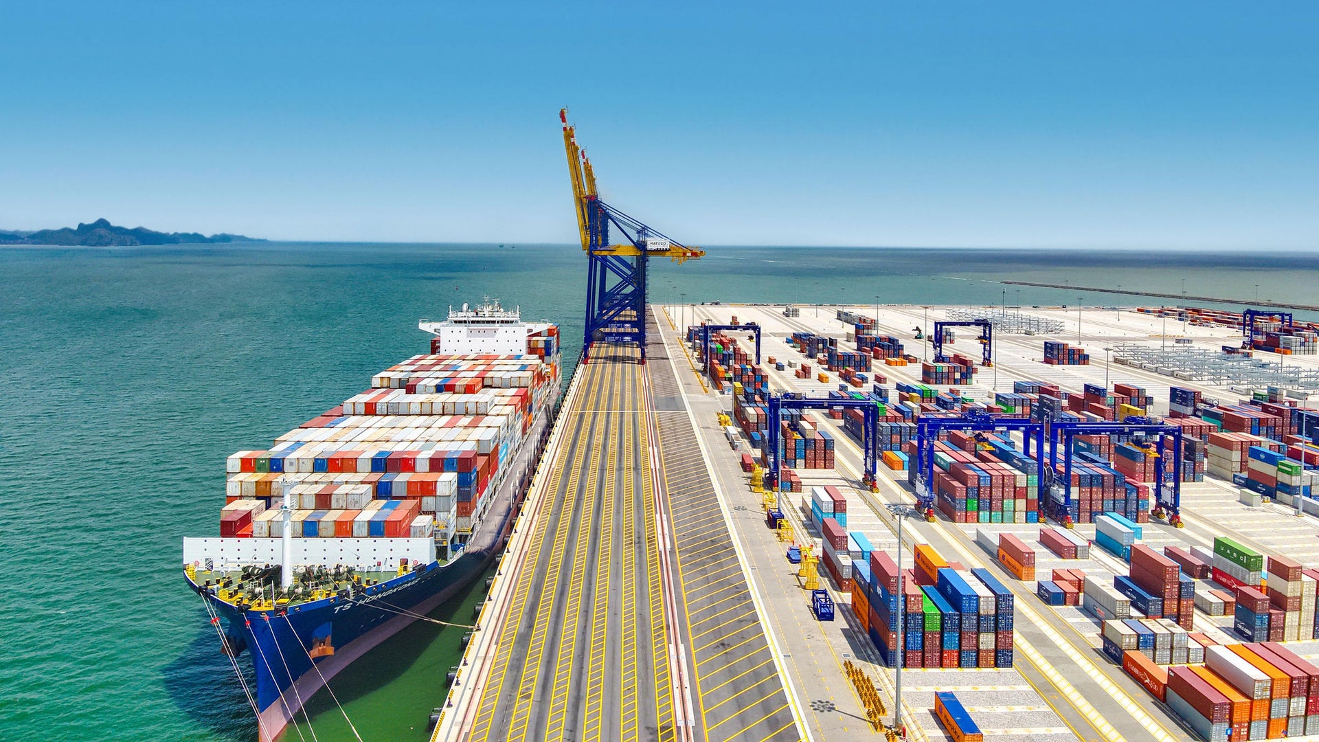 Large Container Ship Docked at Busy Seaport Terminal