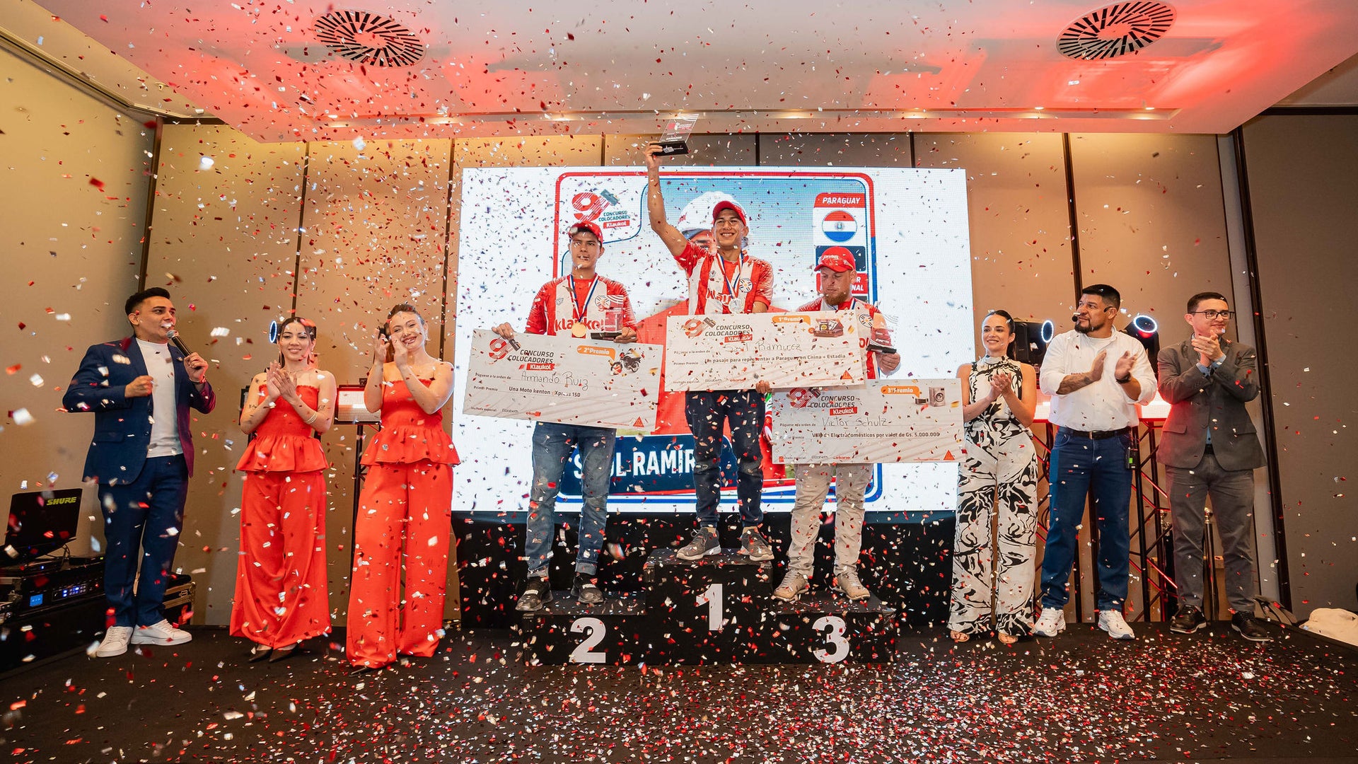 Winners celebrate on podium at confetti ceremony
