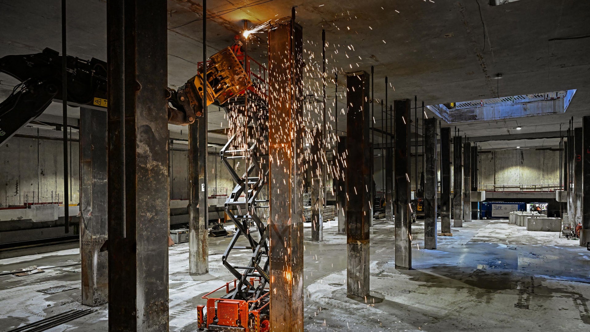 Robotic demolition tool cutting steel beams indoors