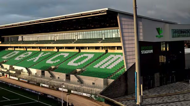 Modern rugby stadium with green seating