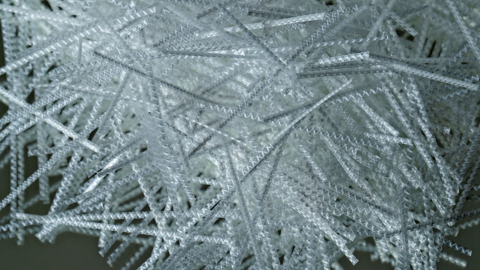 Close-up of white synthetic macro fibers for concrete reinforcement