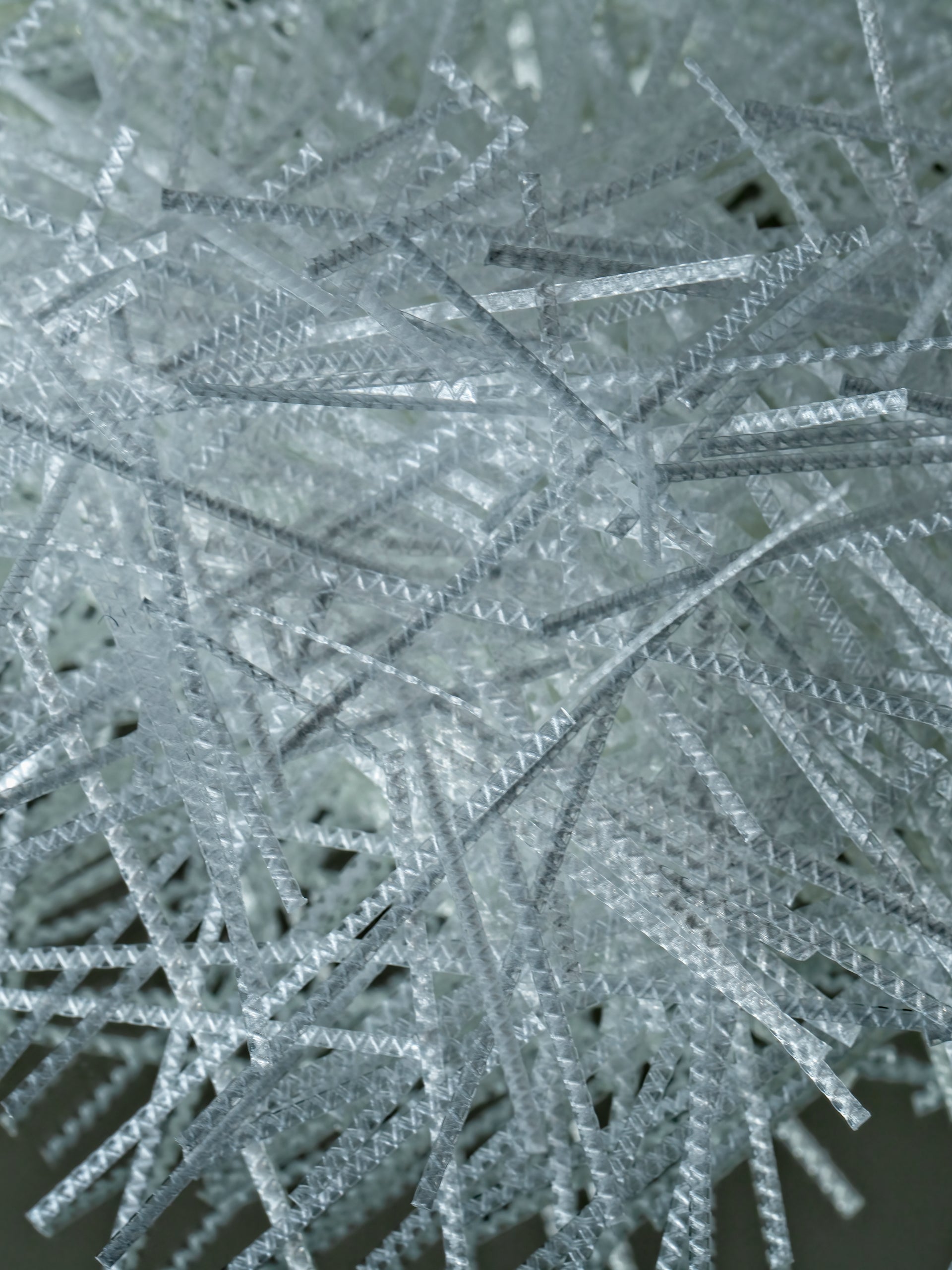 Close-up of white synthetic macro fibers for concrete reinforcement