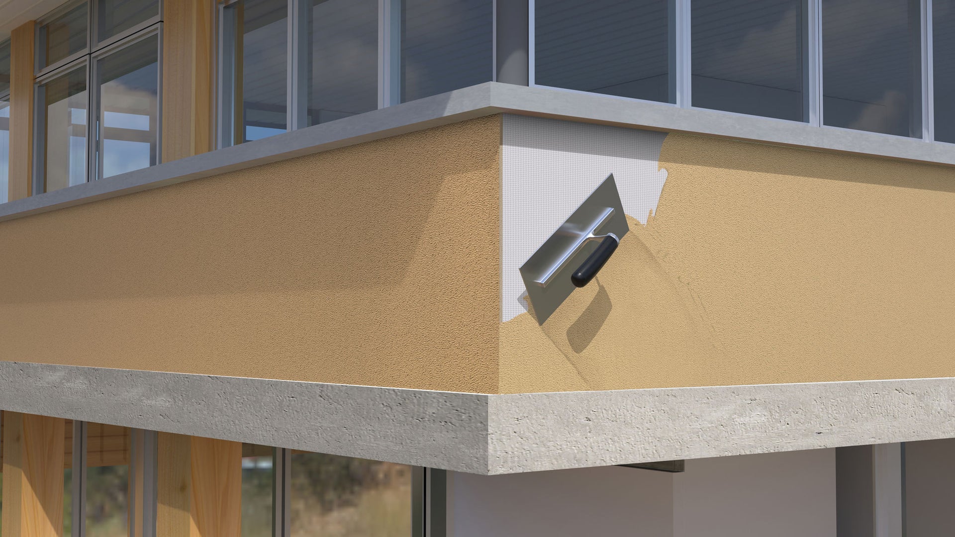 A close-up image of a house corner with a trowel applying a layer of plaster