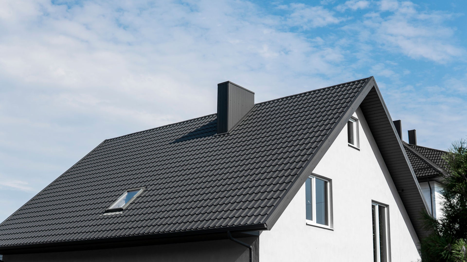 Modern House with Dark Tiled Roof and Chimney