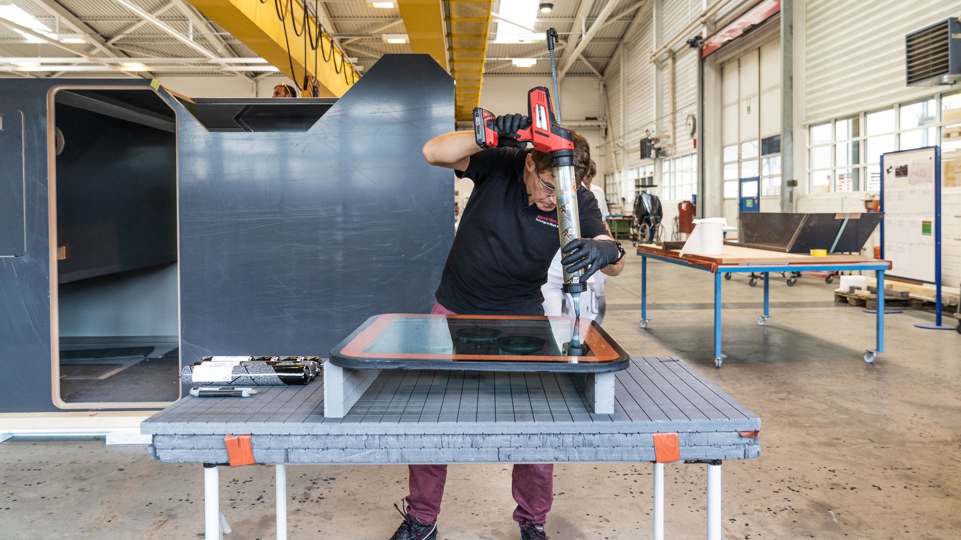 Worker Assembling Industrial Component in Modern Factory
