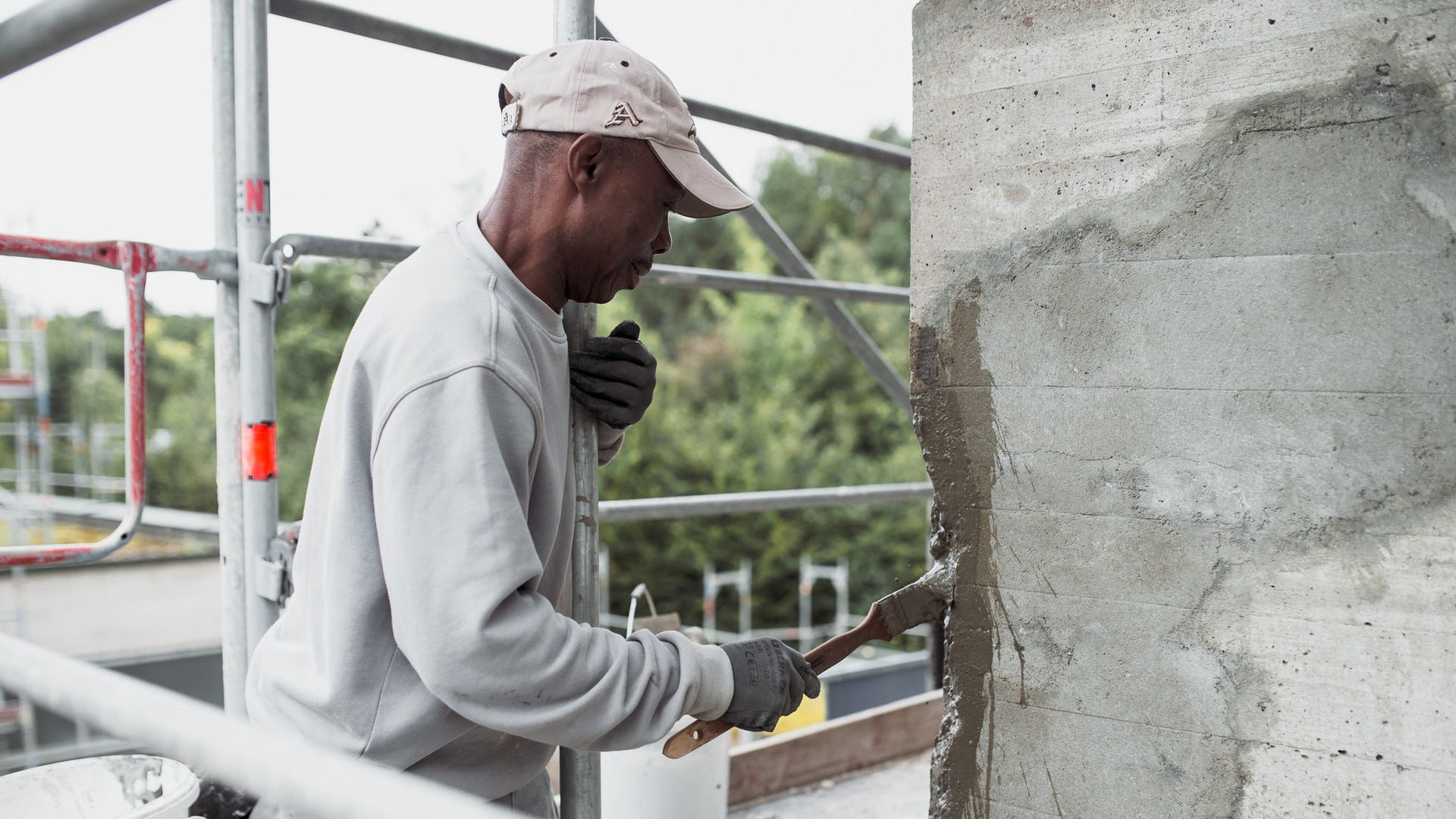 Construction worker repairing concrete wall