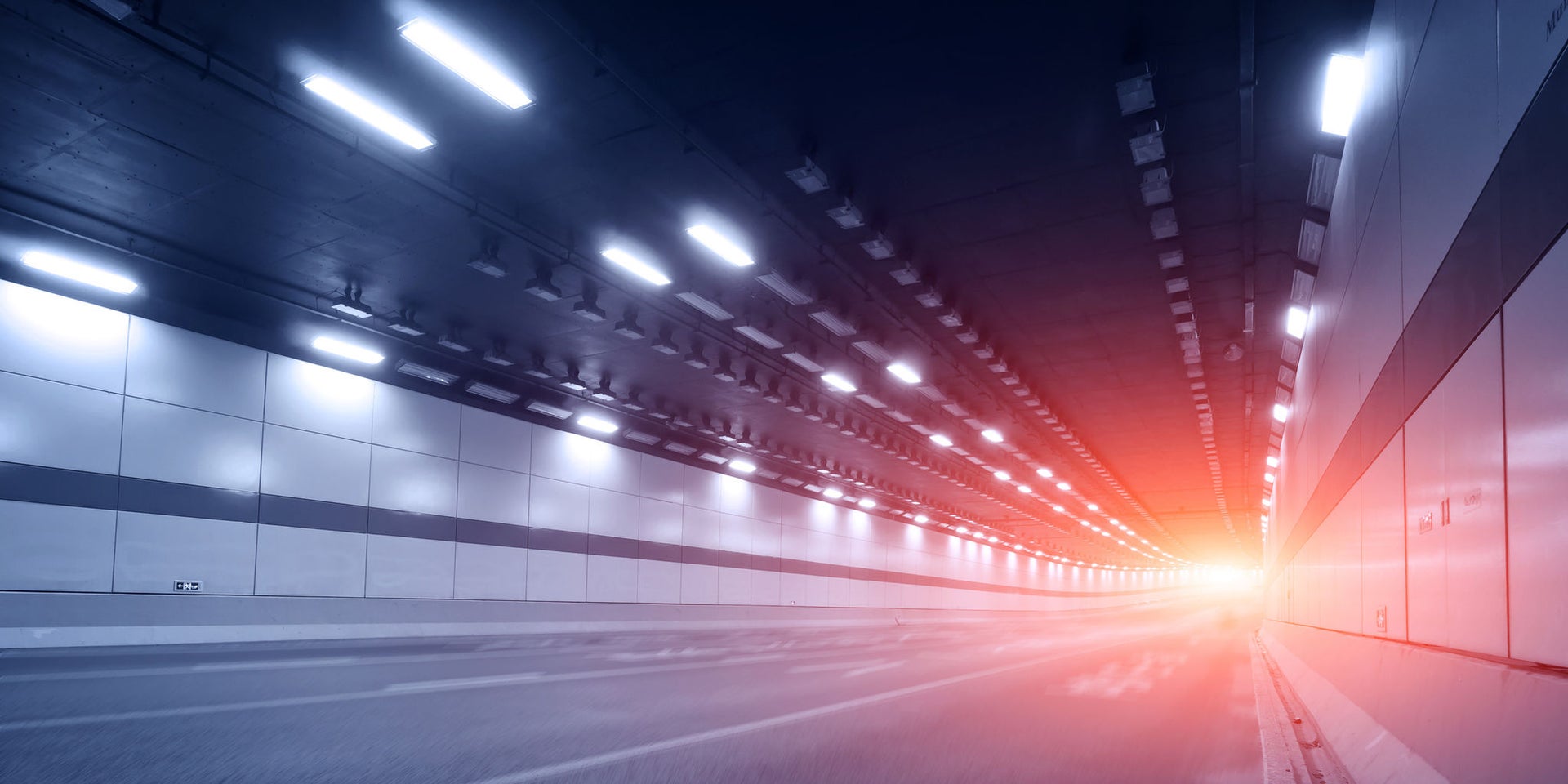Empty highway tunnel with glowing light