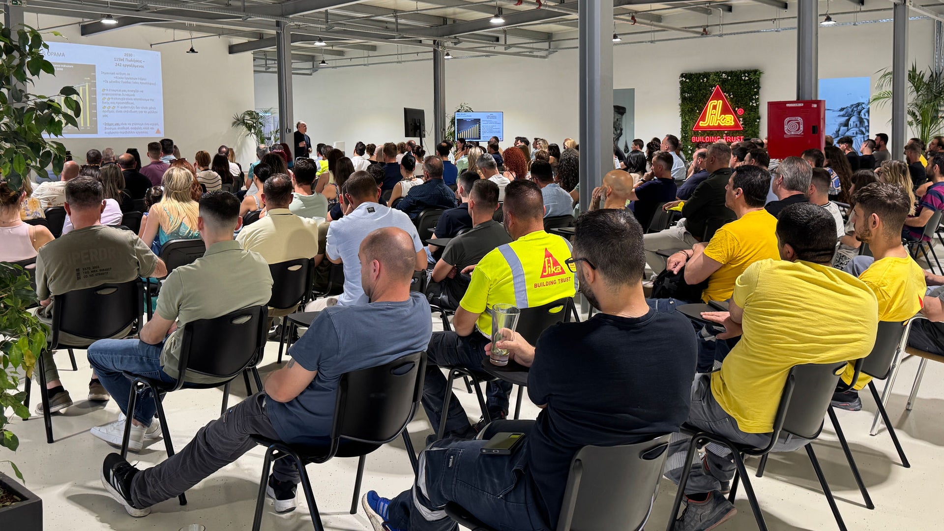 Large audience attending indoor business presentation