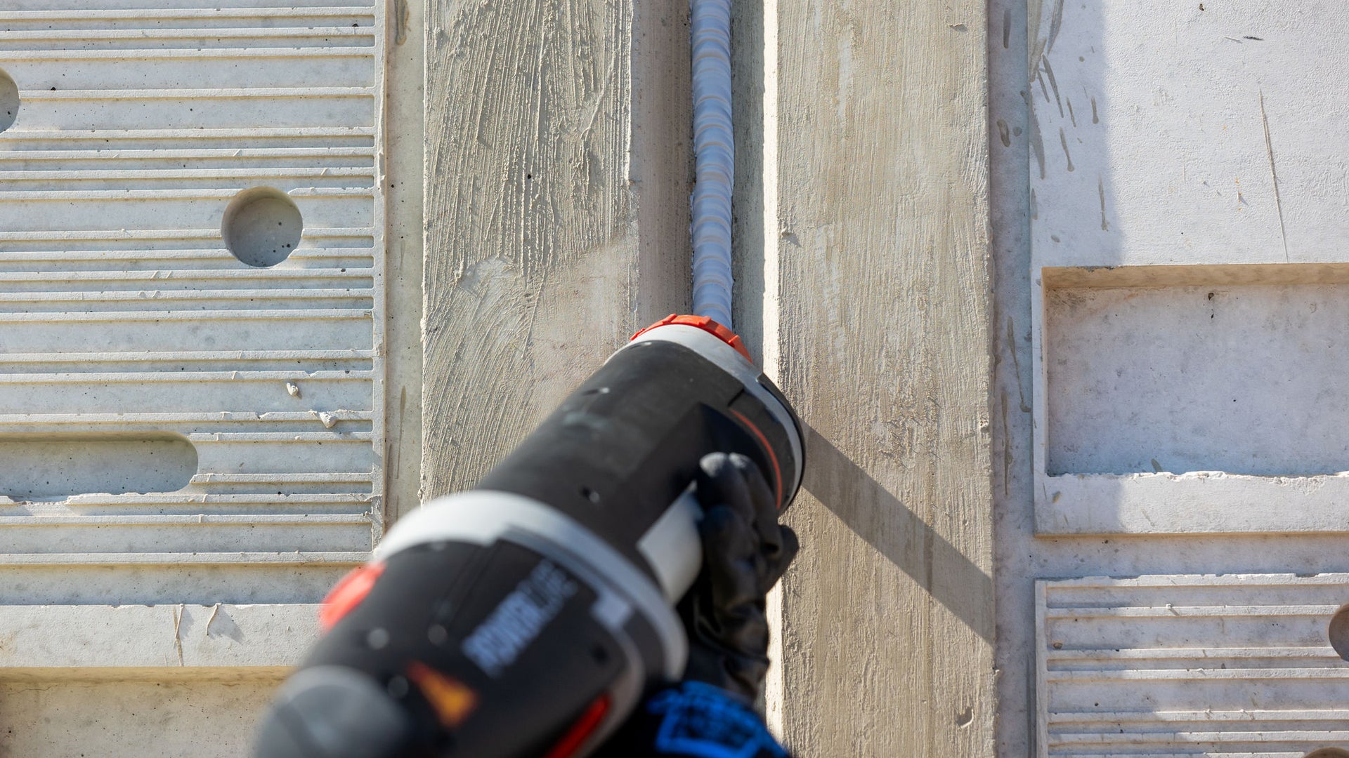 application of Sikaflex joint sealant at sea wall construction joint