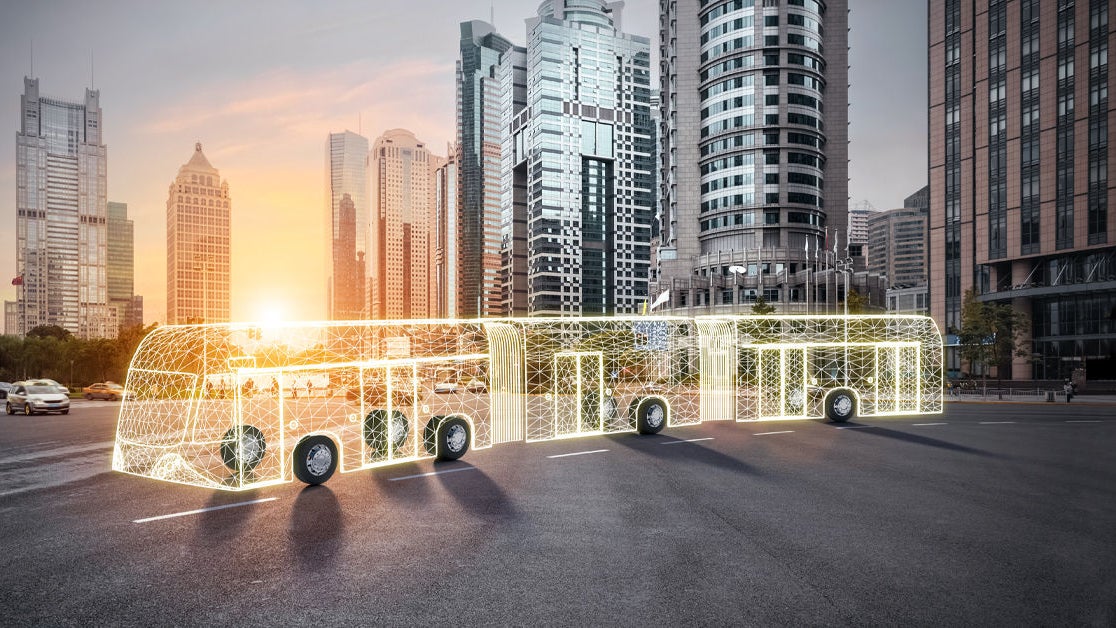 Futuristic electric bus in urban skyline