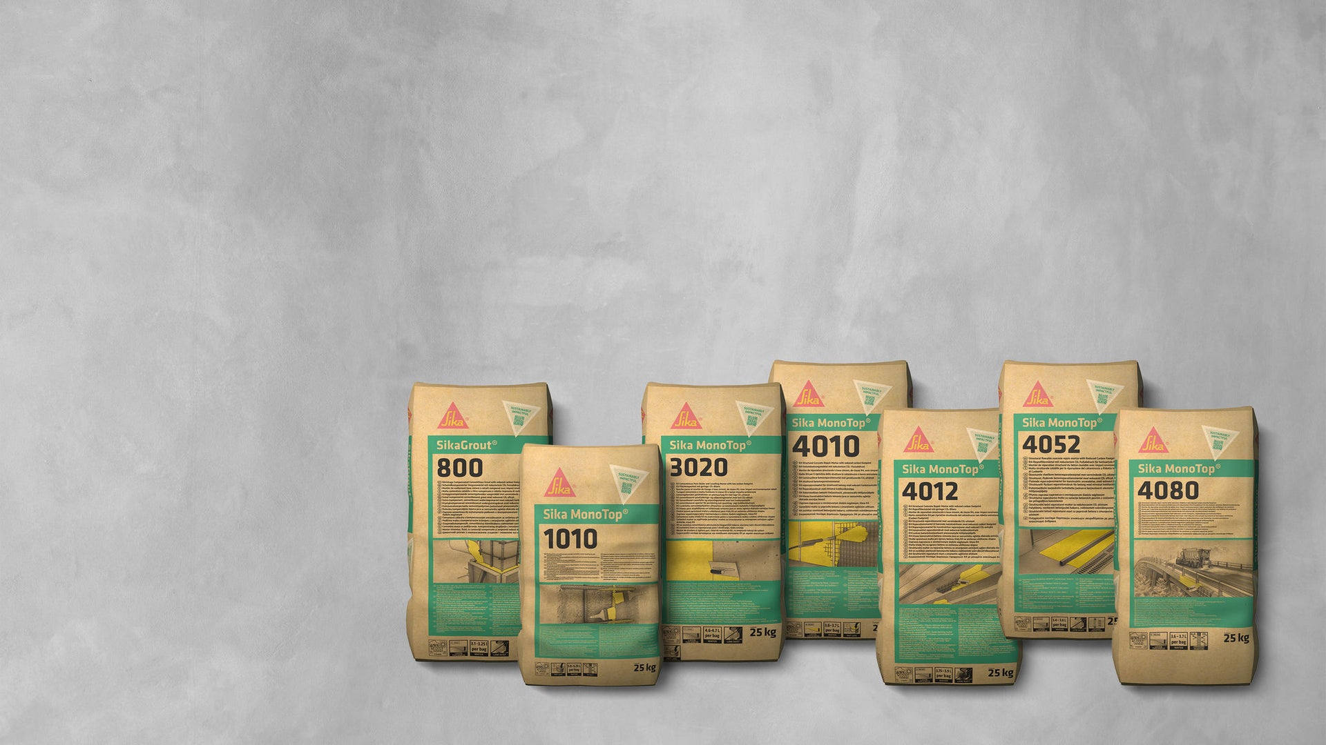 Row of construction material bags on concrete