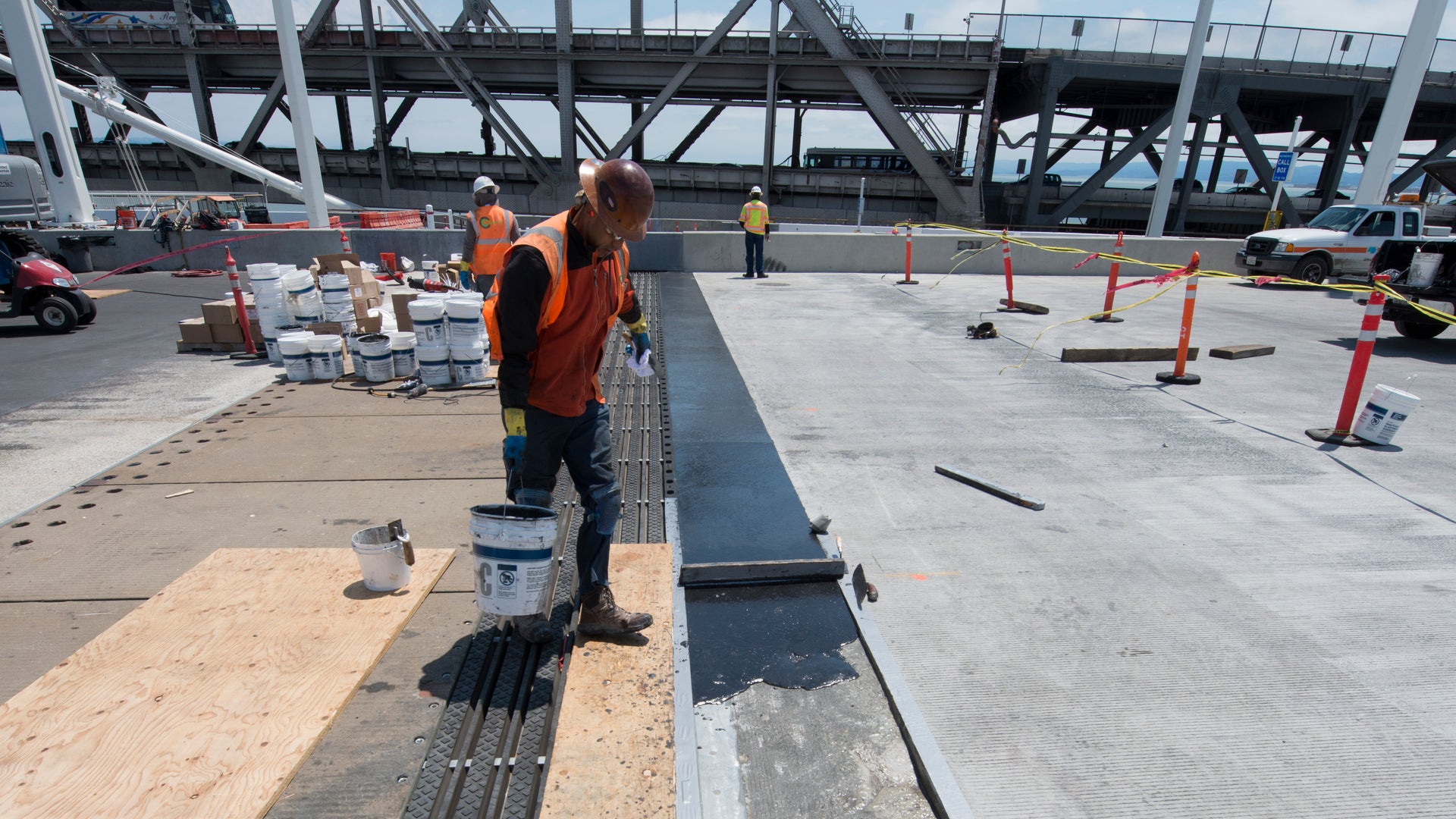 Worker applying material in Wabo expansion joint on Bay Bridge