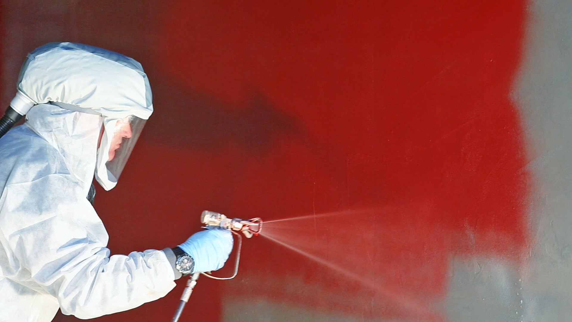 man spraying Sikagard-7000 CR protective coating