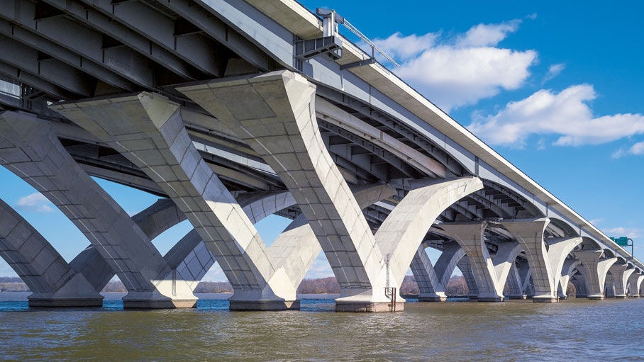 Modern concrete bridge over calm water
