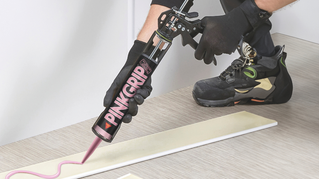 man applying sika pinkgrip adhesive to wood