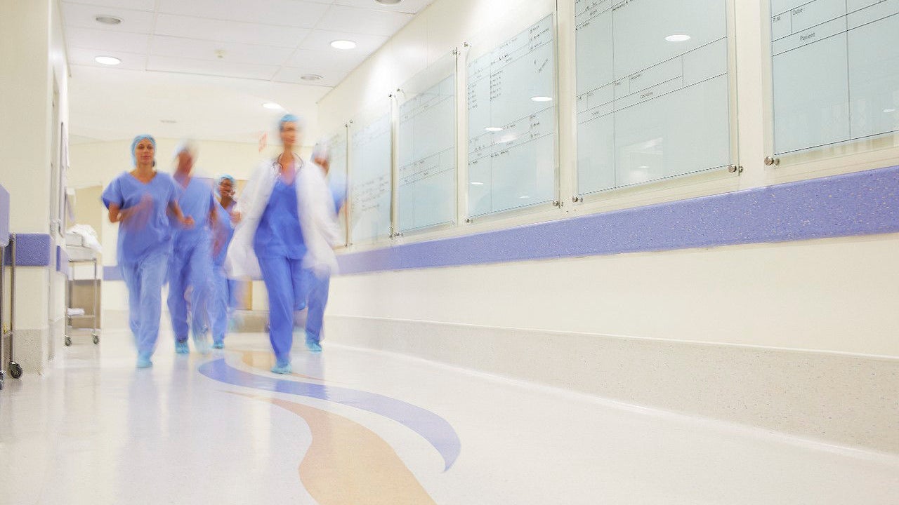Medical team rushing through hospital corridor