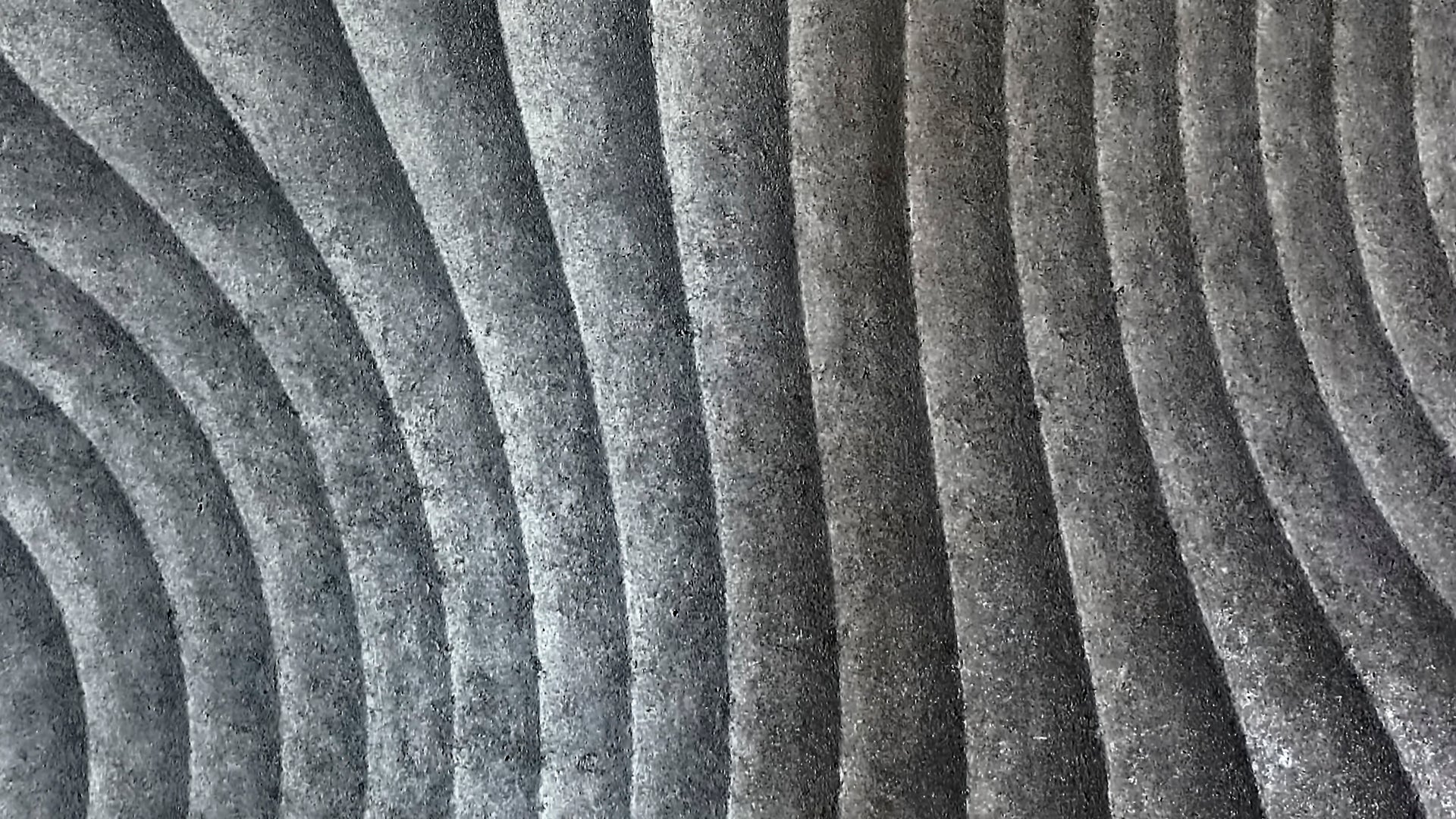 Abstract gray concrete surface with curved grooves