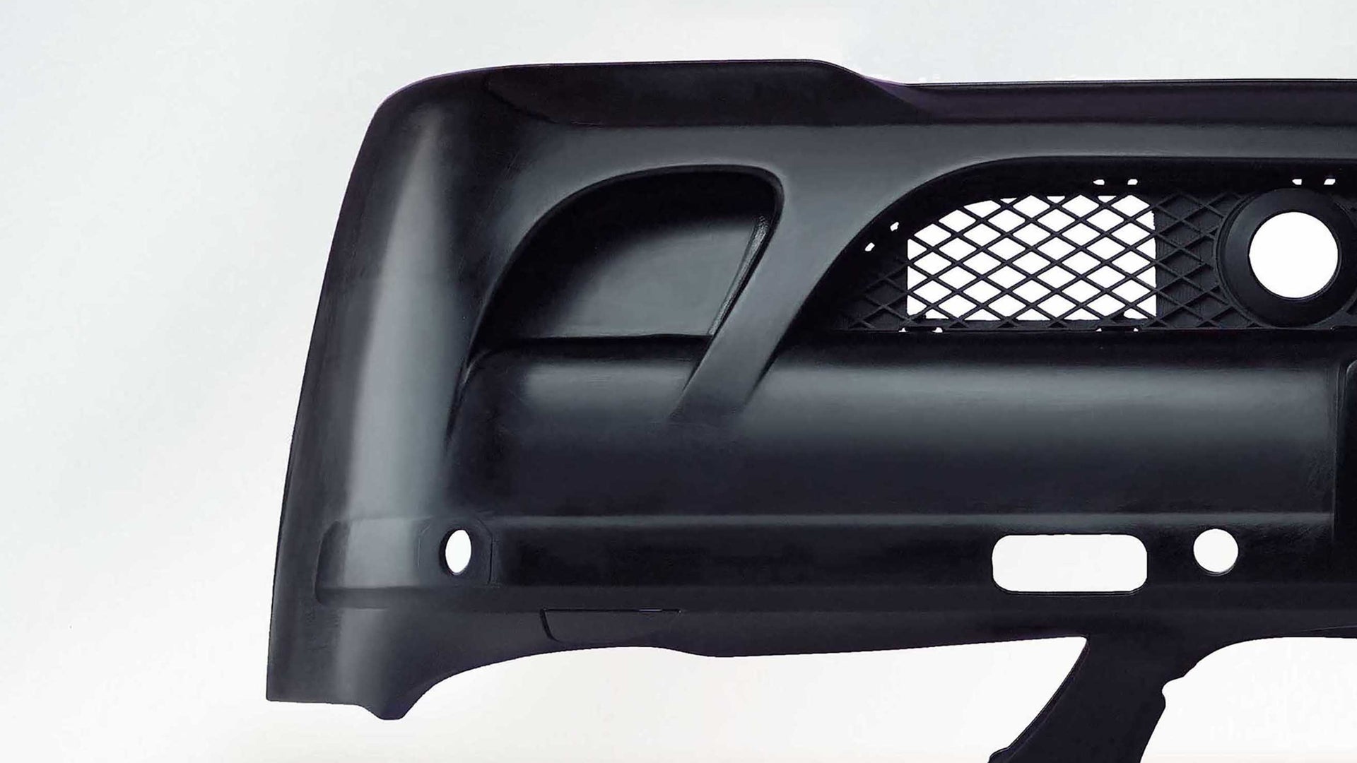 Black automotive bumper component on white