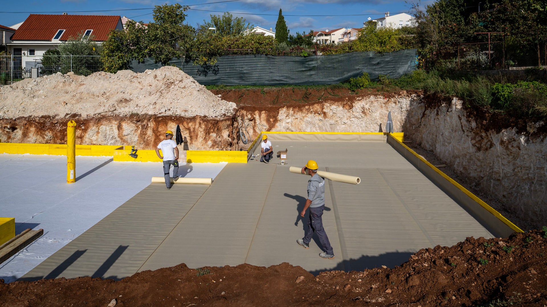 Construction workers preparing building foundation