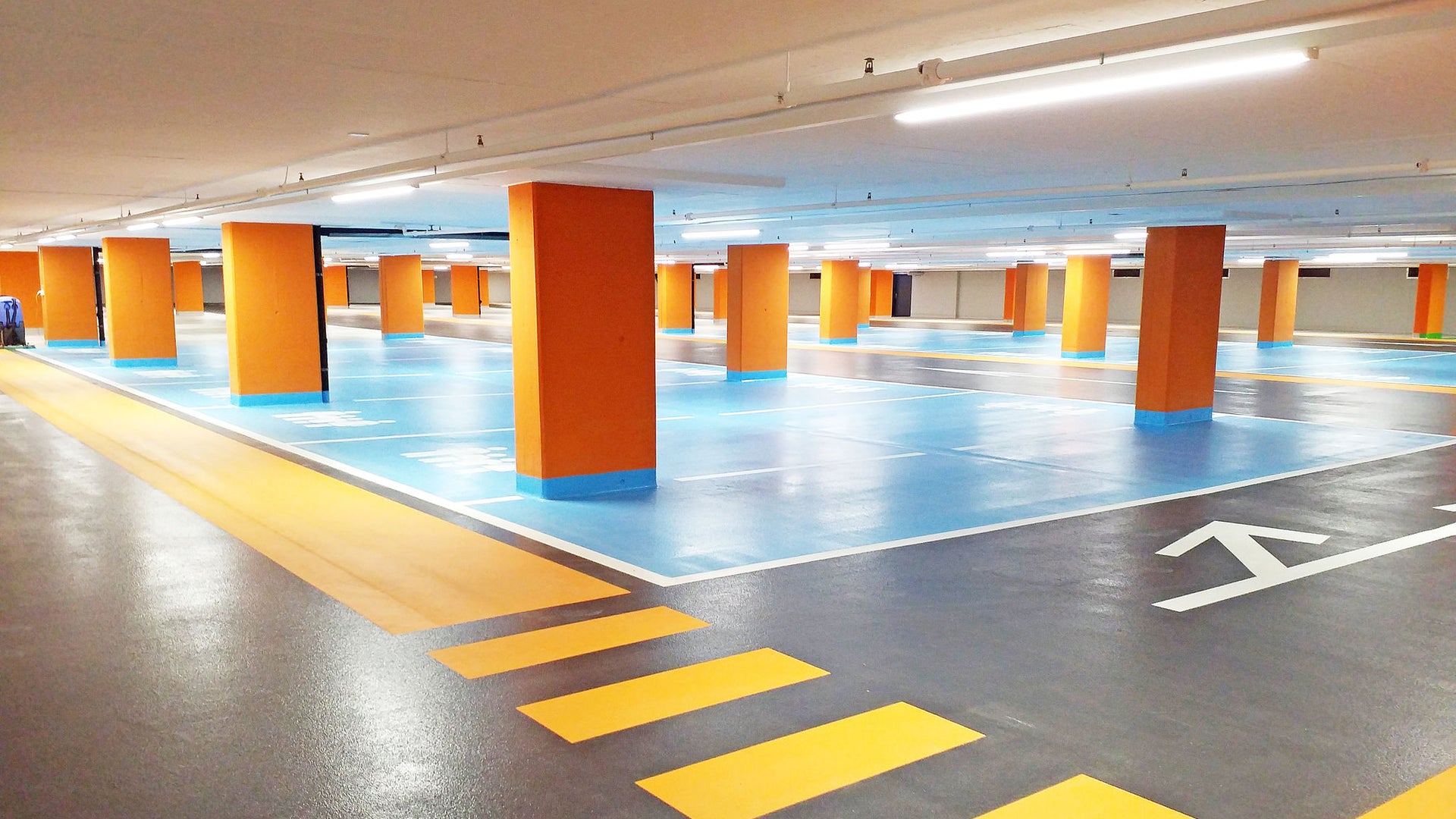 Seedam Center car parking garage floor with yellow, blue parking and orange columns