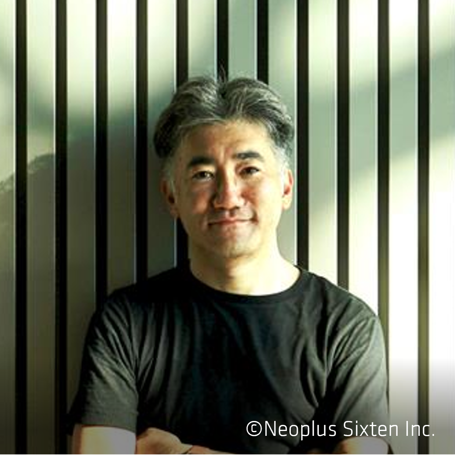 Man in black shirt against striped wall