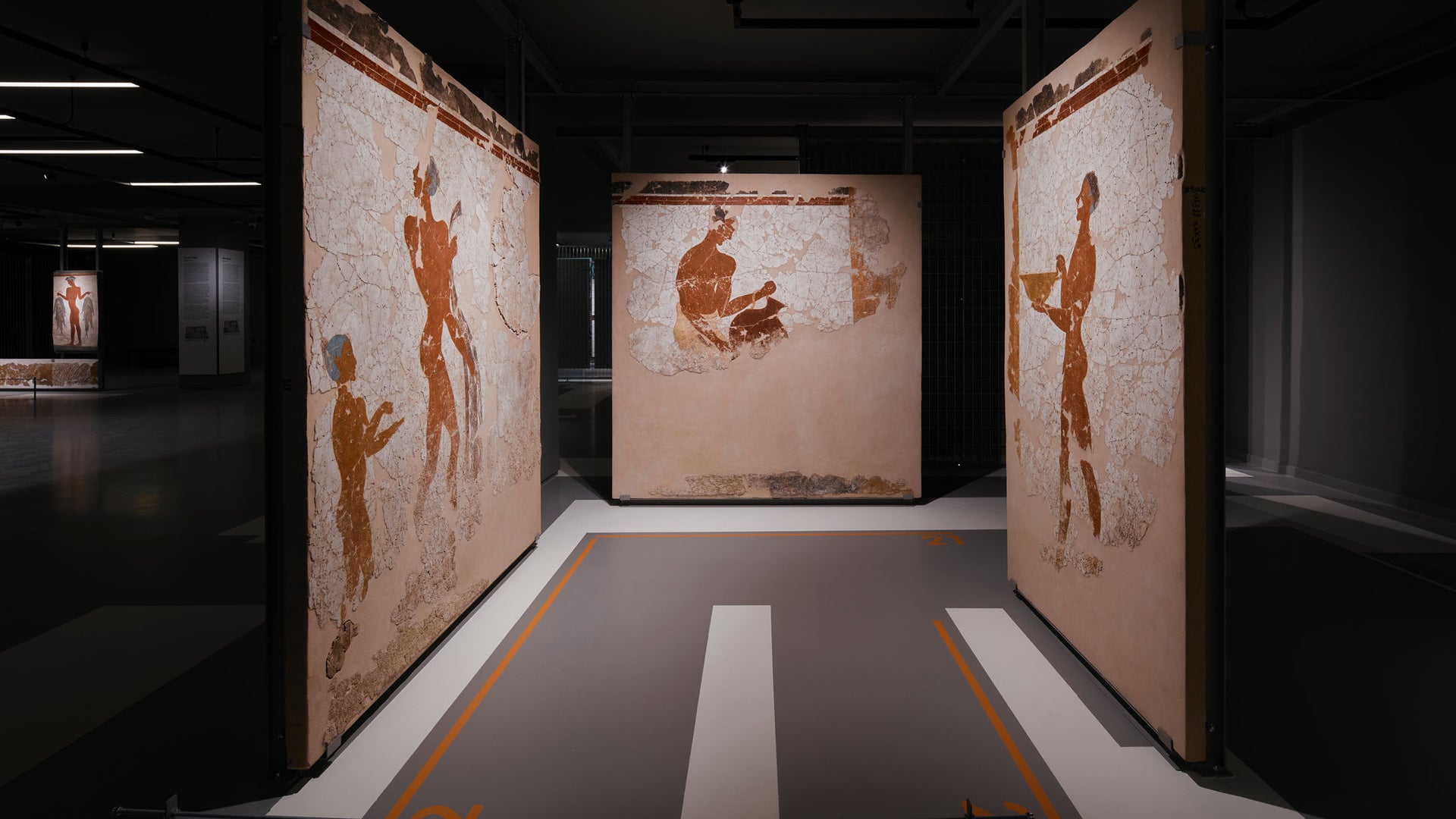 Ancient mural panels displayed in modern gallery