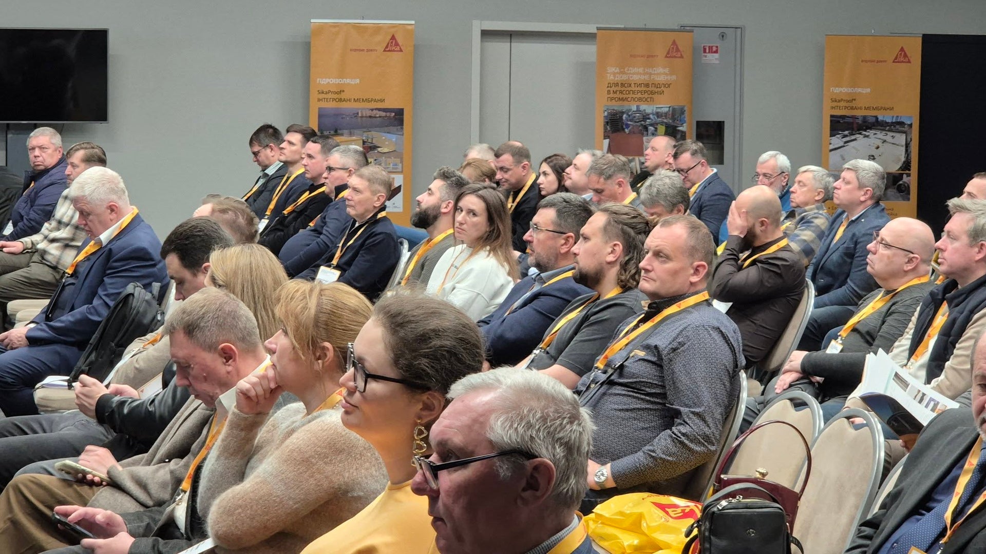 Business conference audience listening to presentation