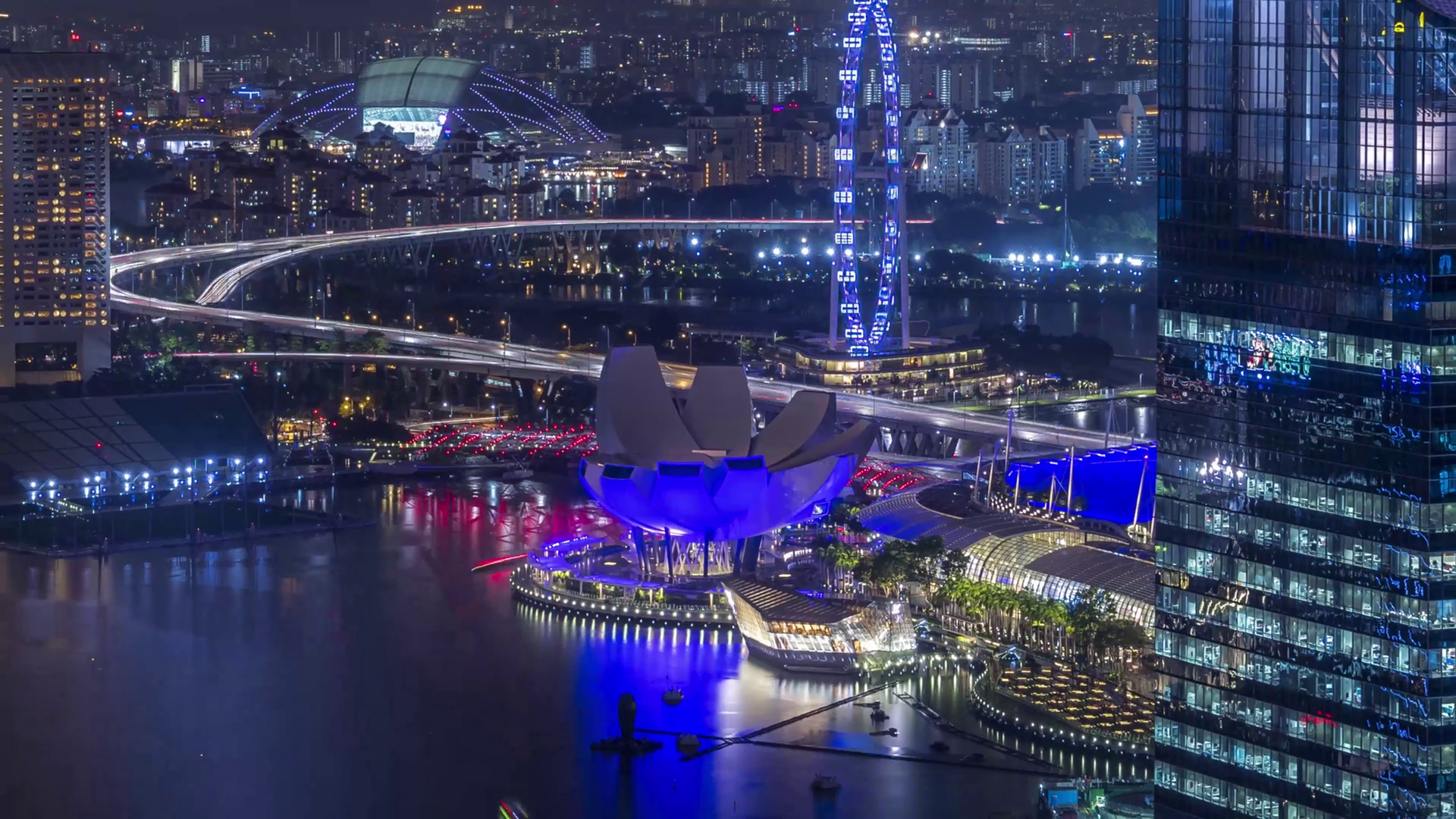 Futuristic waterfront cityscape at night