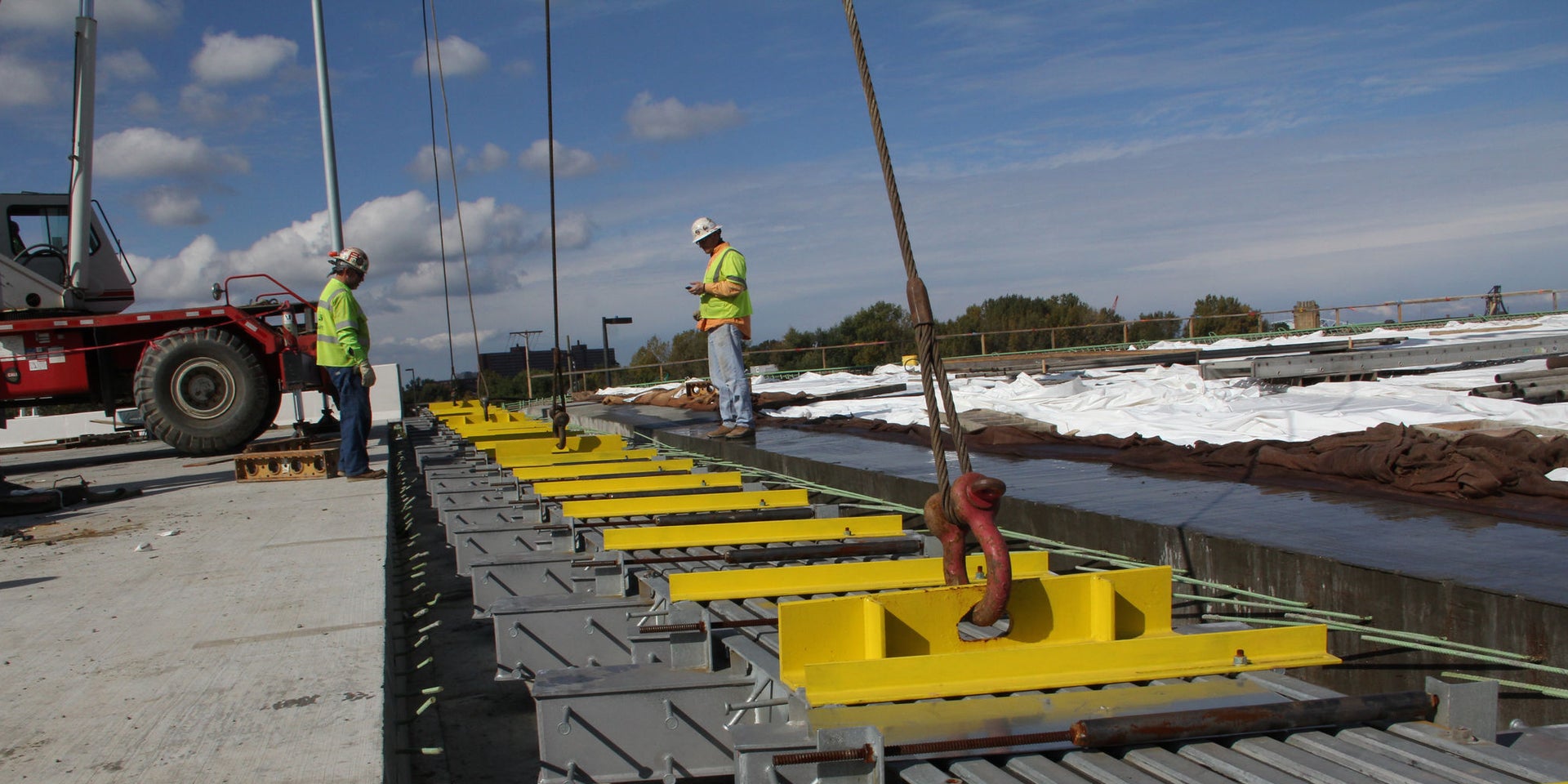 Construction workers installing structural steel beams