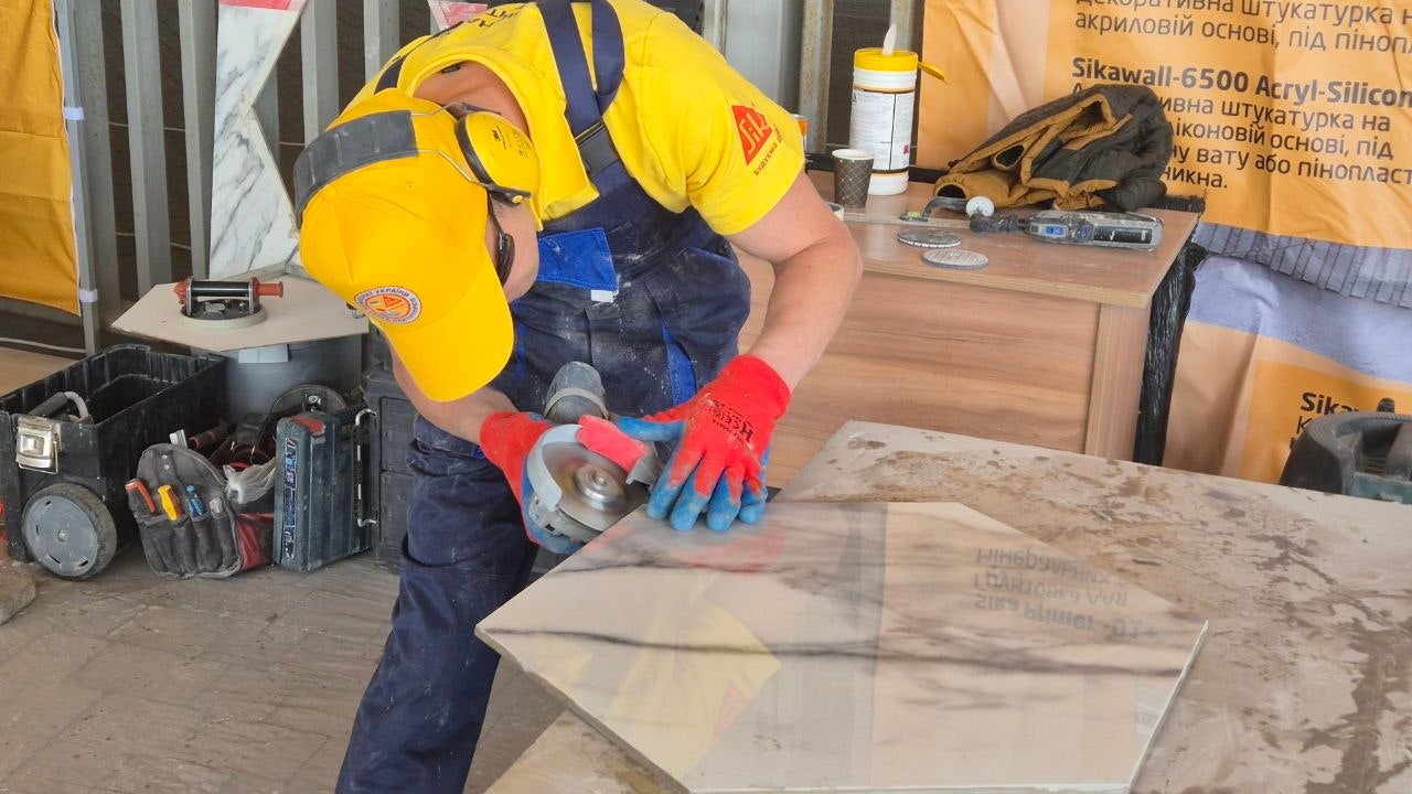 Construction worker cutting large ceramic tile