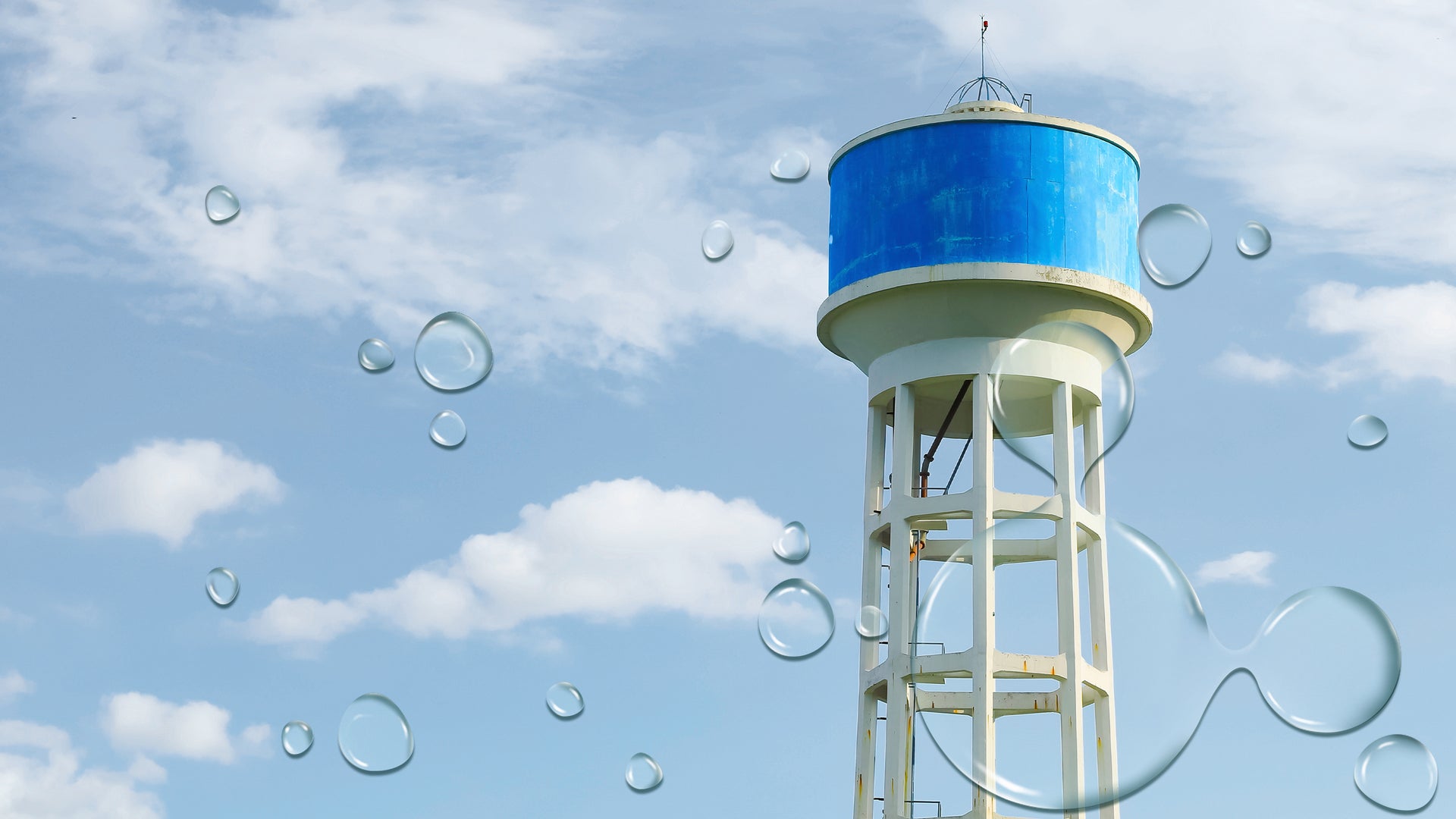 Blue water tower with blue sky clouds